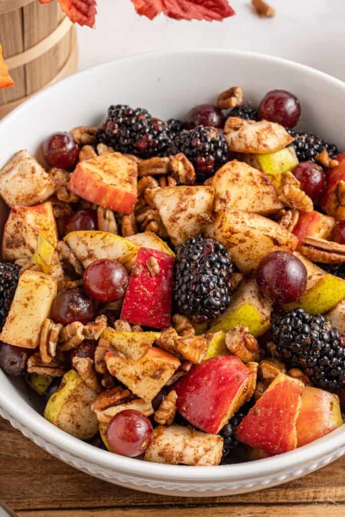 Close up of the Thanksgiving fruit salad in a white bowl.