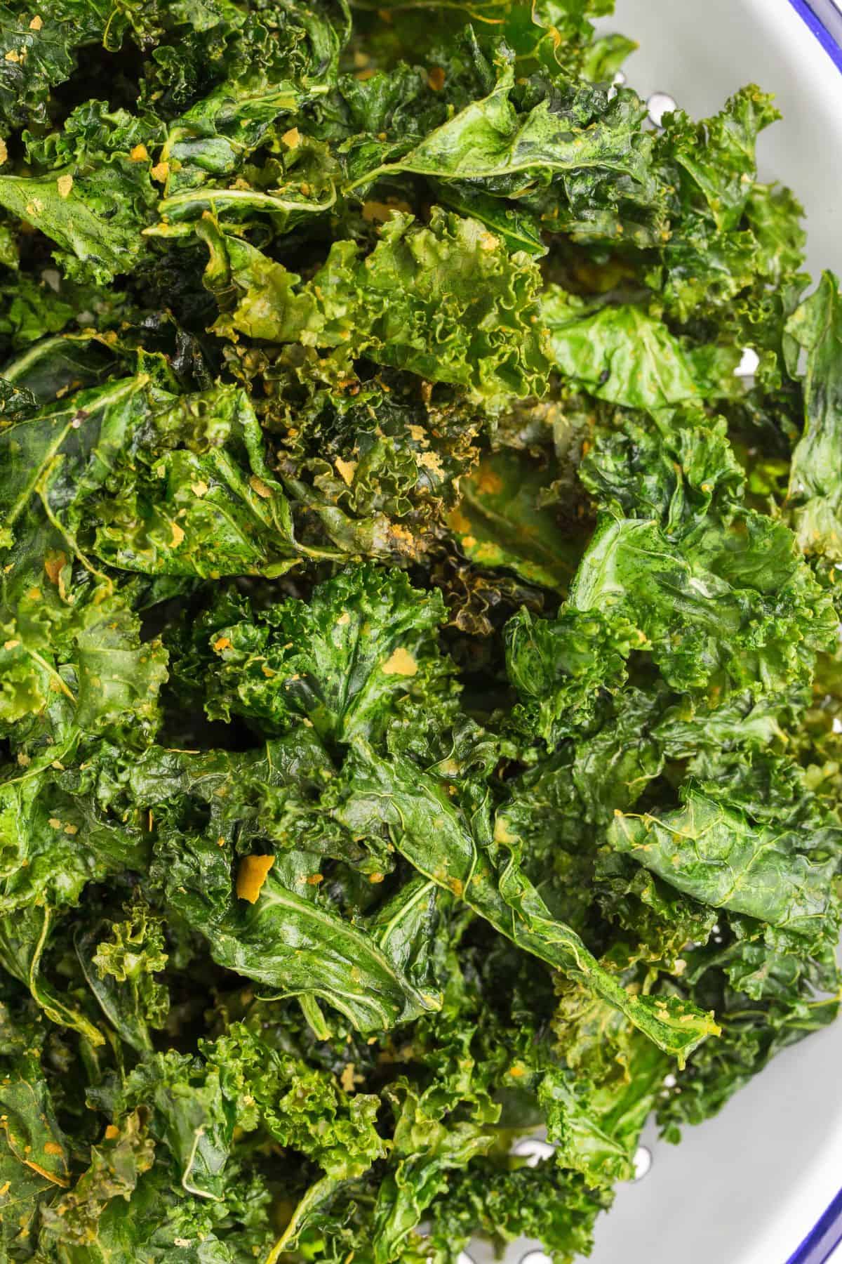 Close up of air fried kale chips to show the crispy edges.