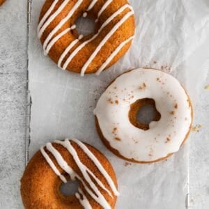 Pumpkin spice donuts with vanilla icing on top.