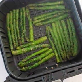 air fryer basket with asparagus