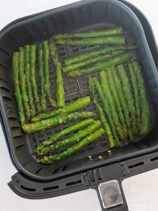 air fryer basket with asparagus