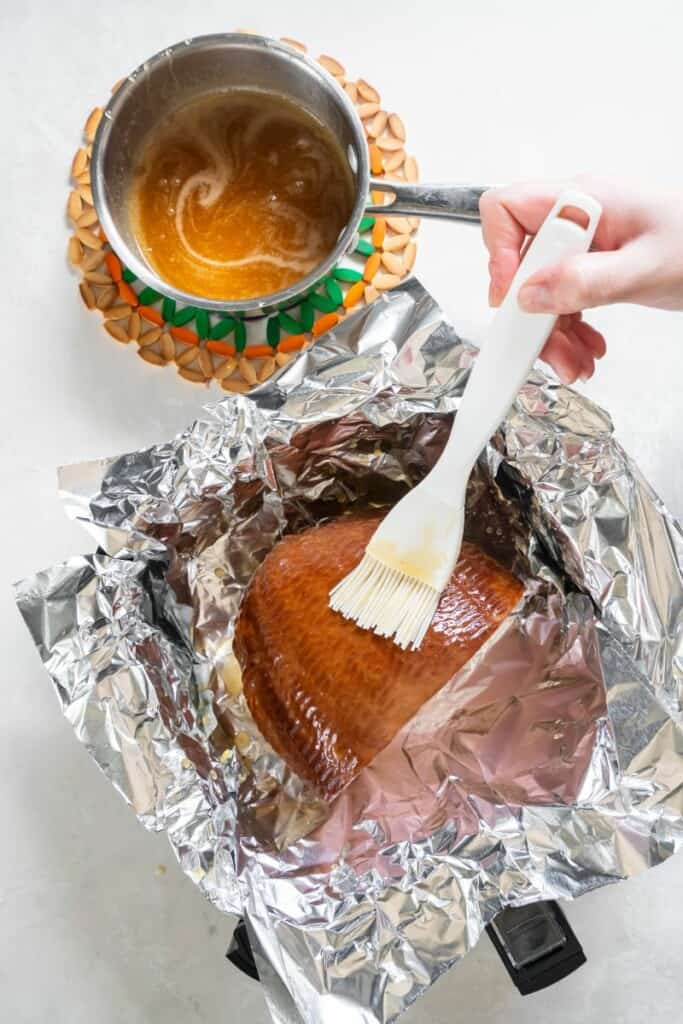 brushing liquid onto ham