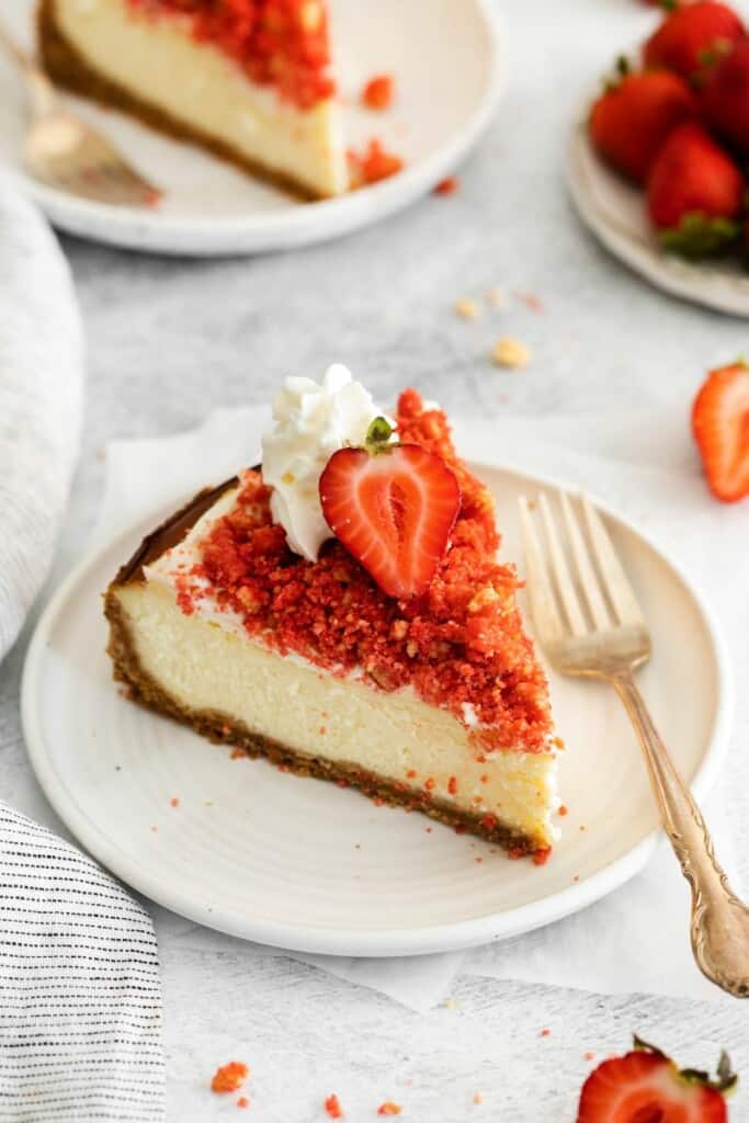 piece of strawberry crunch chesecake on plate