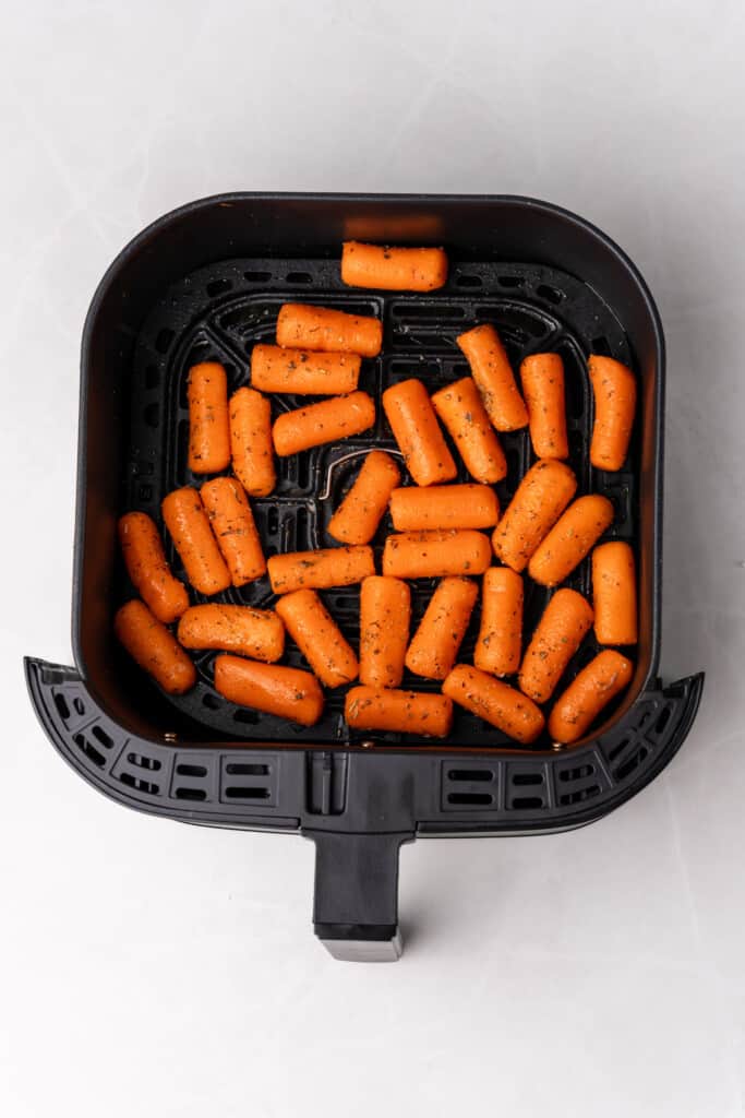 uncooked carrots in air fryer basket