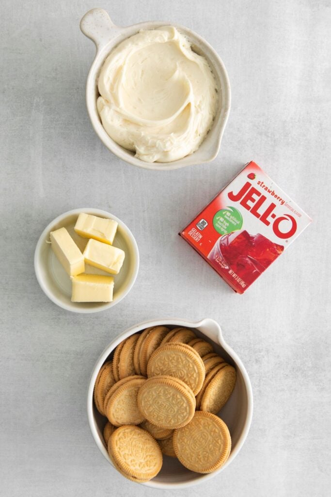 Strawberry crunch topping for the strawberry crunch cheesecake recipe: butter, strawberry jello, golden Oreos, and frosting.