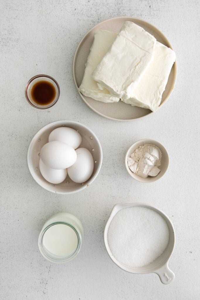 Cheesecake ingredients for the strawberry crunch cheesecake: butter, cream cheese, sugar, milk, flour, vanilla, and eggs.