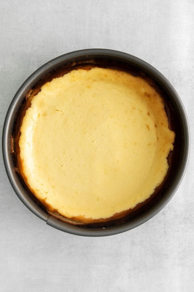 The strawberry cheesecake crunch cake with the cheesecake part just baked in the oven and no topping on it.