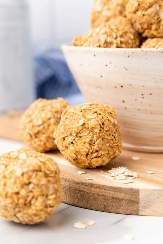 3 Ingredient Peanut Butter Oatmeal Balls in a bowl and on a cutting board