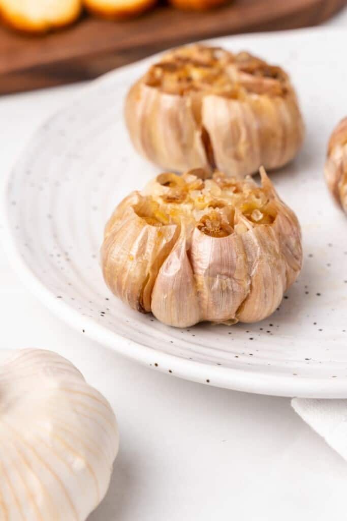 roasted garlic on a white plate
