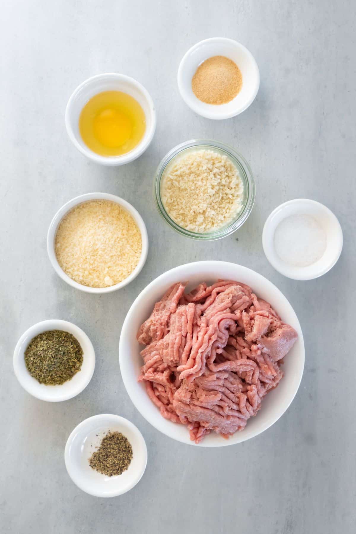 Ingredients needed to make air fryer turkey meatballs: ground turkey, breadcrumbs, parmesan cheese, egg, italian seasoning, garlic powder, salt, and pepper.