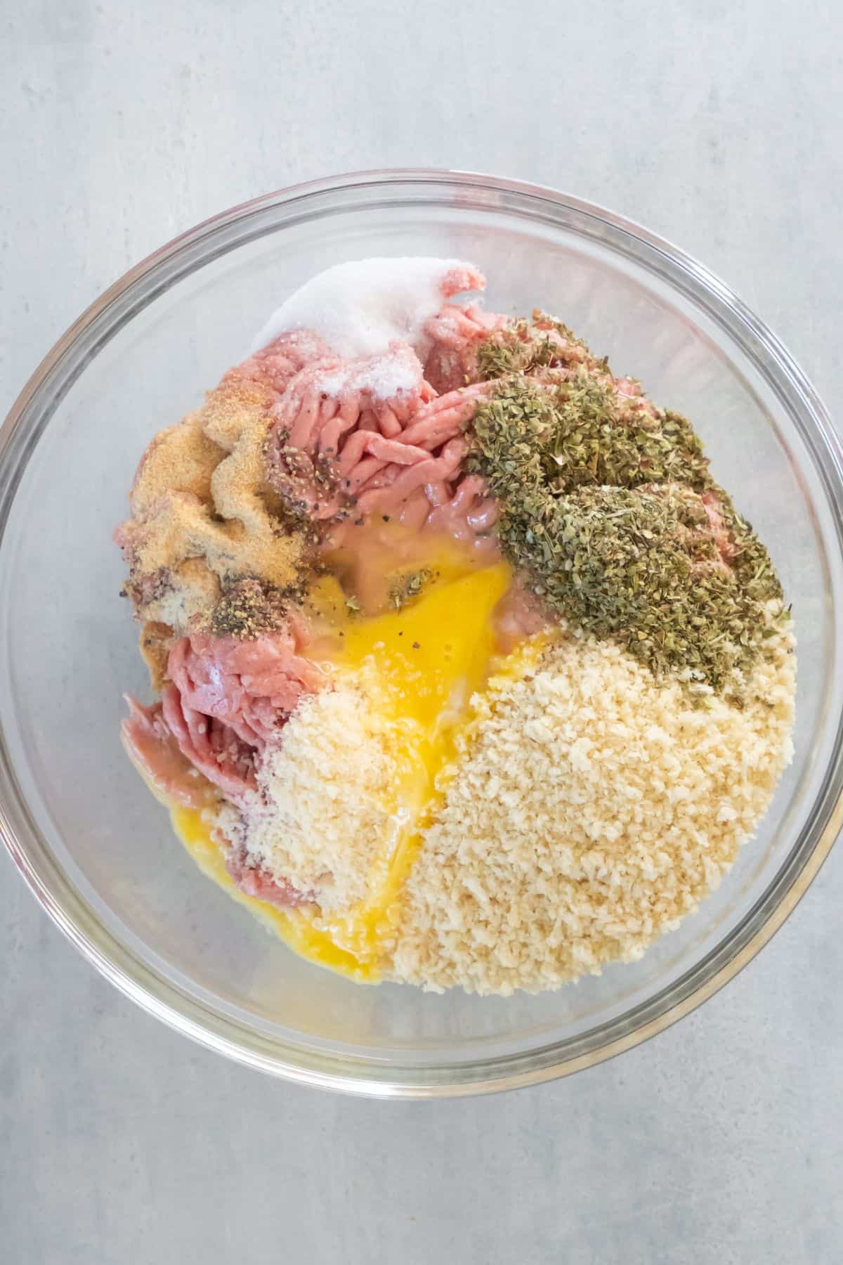 Ground turkey and the rest of the ingredients added to a bowl.