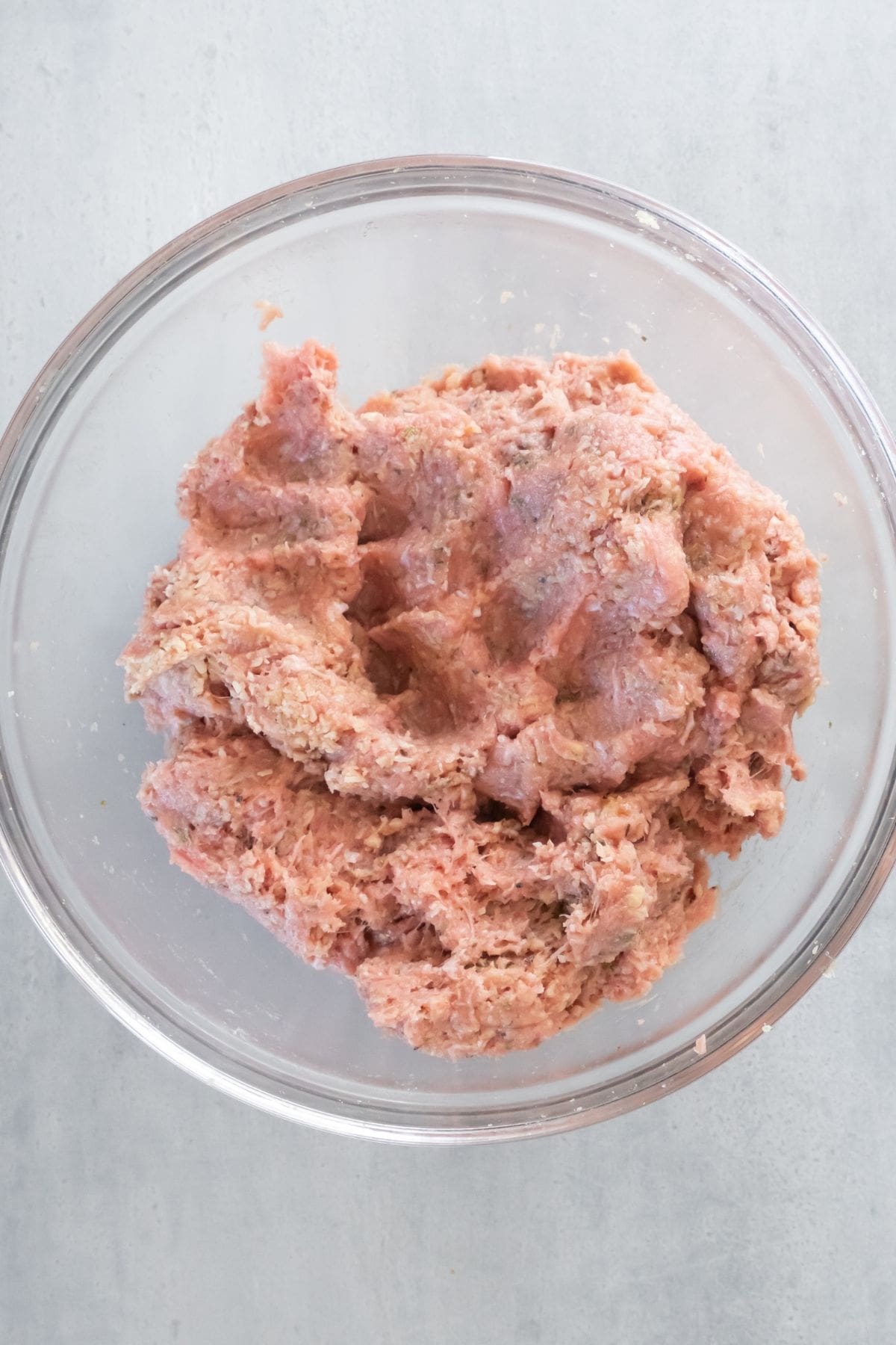 Ground turkey and ingredients compared to make the turkey meatball mixture.