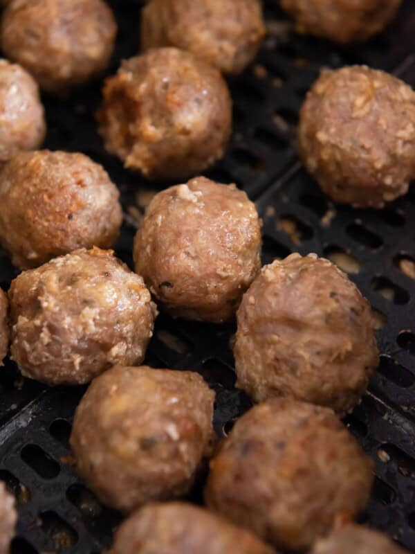 Close up of turkey meatballs in the air fryer basket.