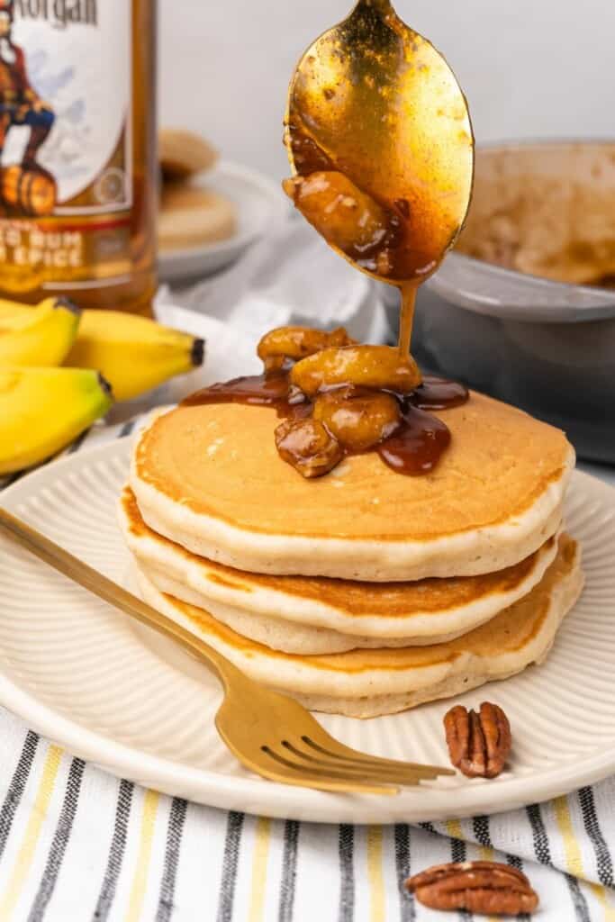 stack of pancakes with banana sauce