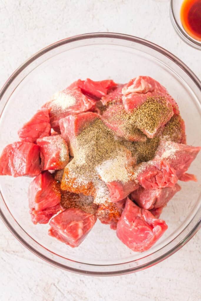 raw beef with seasonings in a bowl