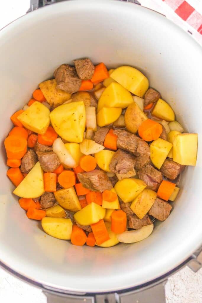 adding vegetables to beef for beef stew