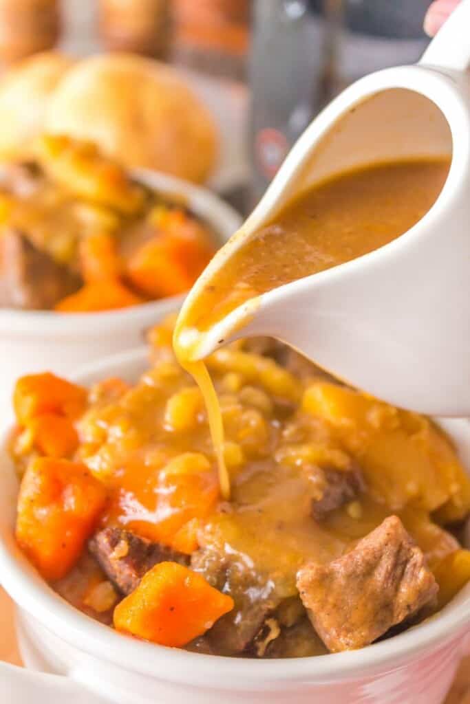 pouring gravy on beef stew