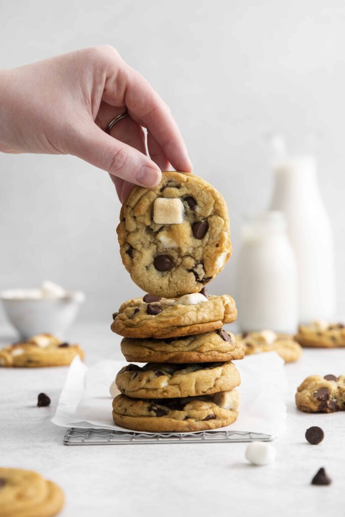stack of cookies with handing holding one cookie up