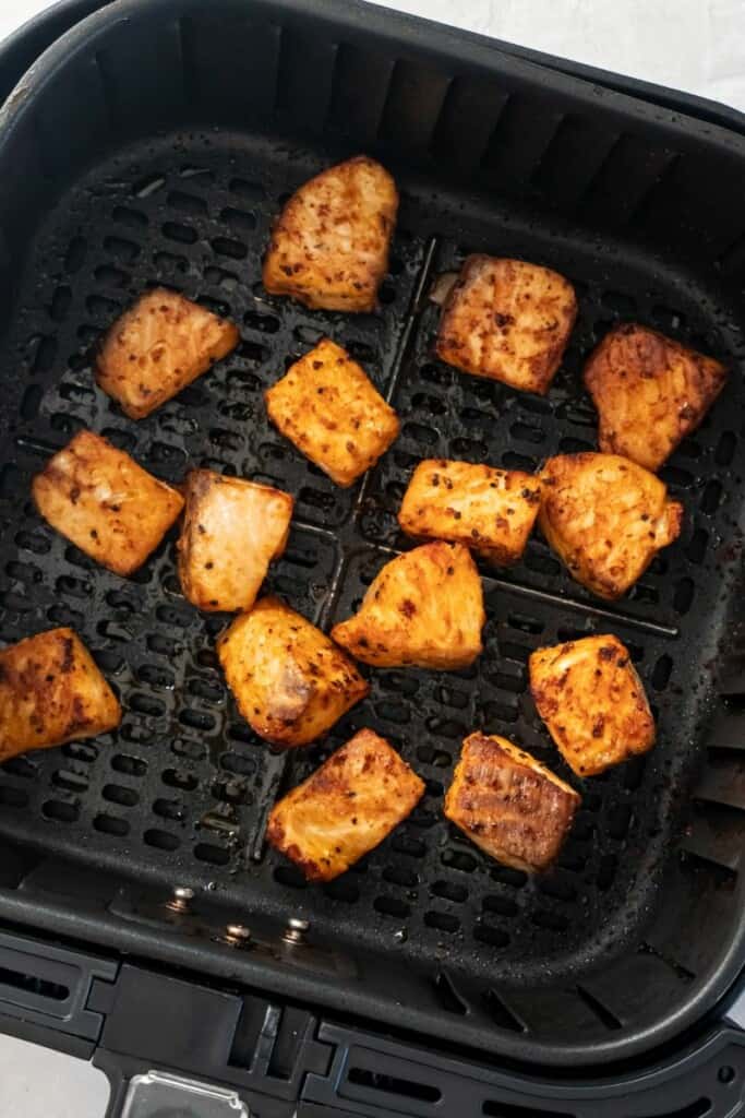 cooked salmon bites in air fryer basket