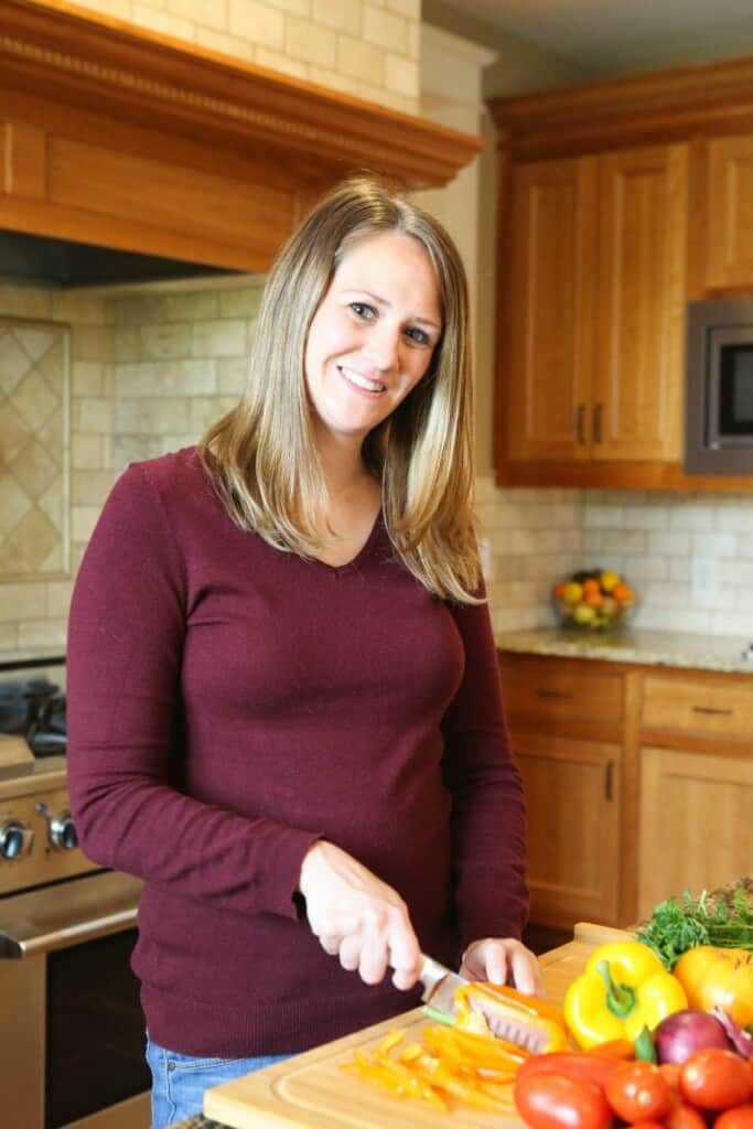 Samantha cutting a pepper in a kitchen