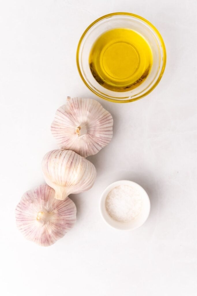 Ingredients needed to roast garlic in the air fryer: garlic bulbs, olive oil, and salt.