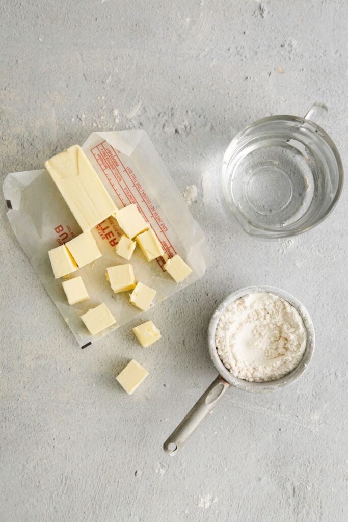 Ingredients needed to make a homemade pie crust: all-purpose flour, cold butter, and ice cold water.