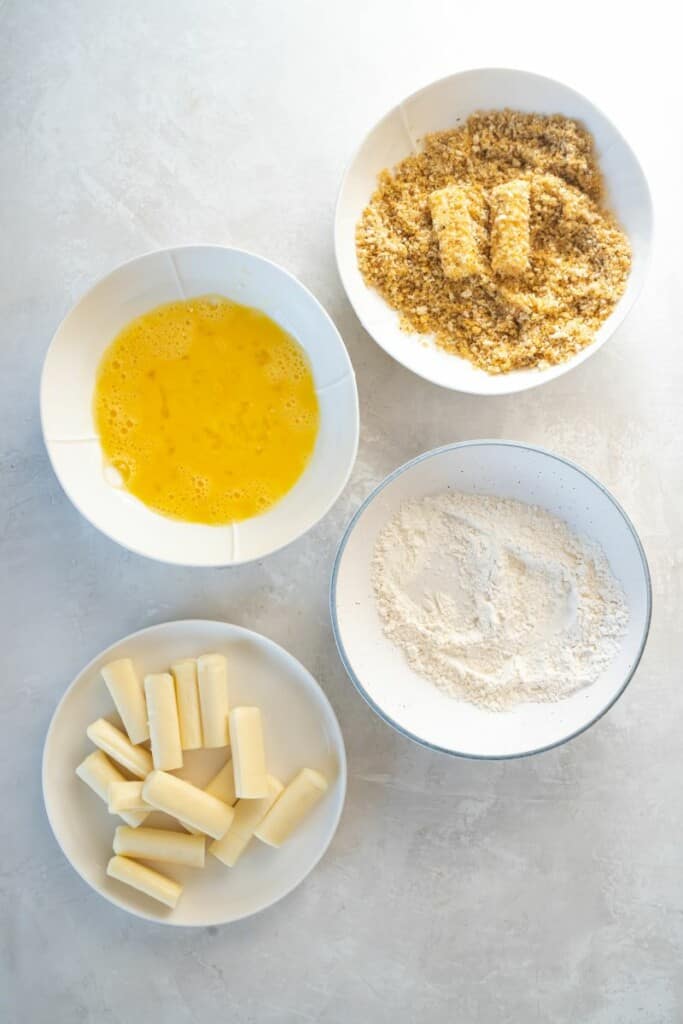 mozzarella sticks and other ingredients in bowls