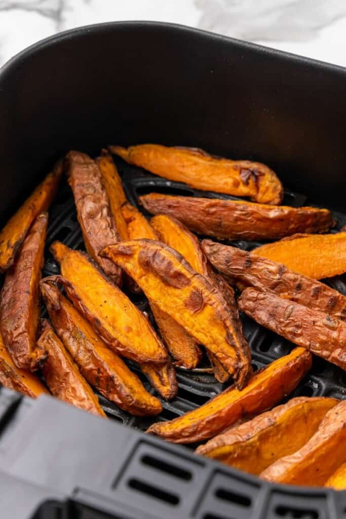 air fryer basket with sweet potato wedges
