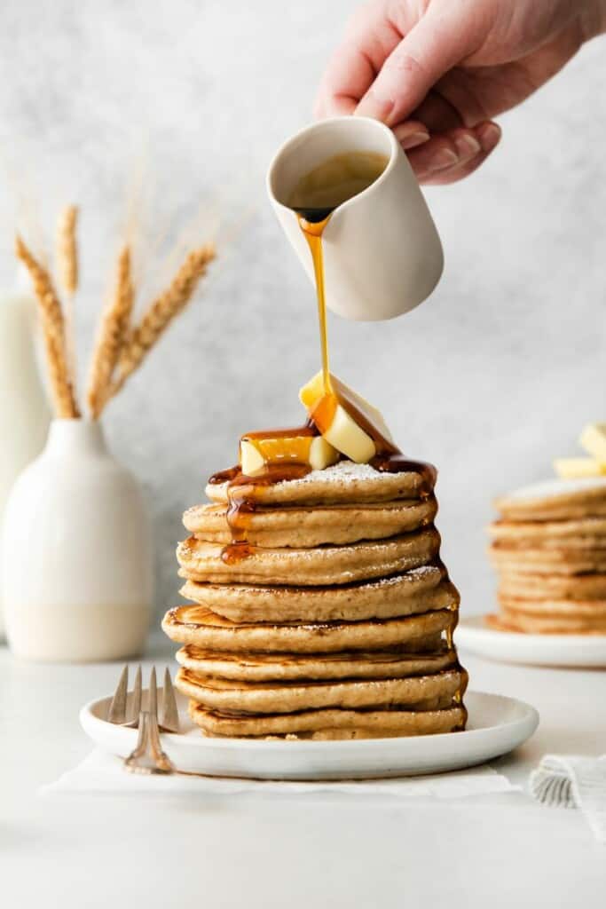 pouring syrup on pancakes