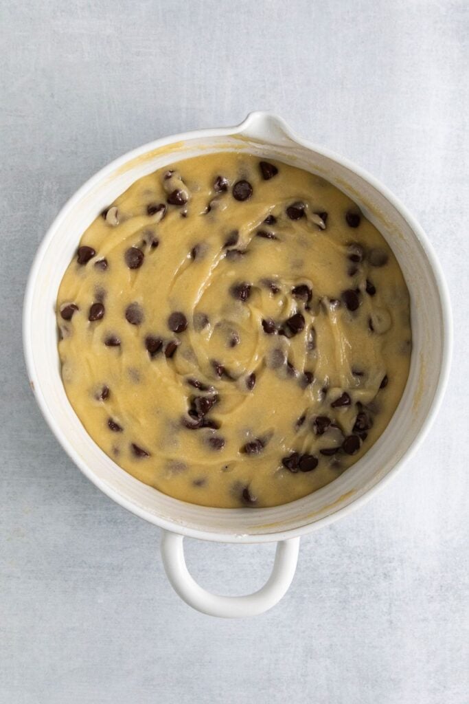 Chocolate chip cookies without brown sugar batter in a mixing bowl.