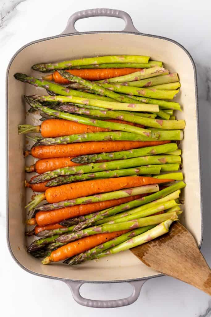 Asparagus and carrots roasted in a baking dish.