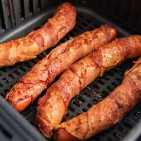 closeup of bacon wrapped hot dogs