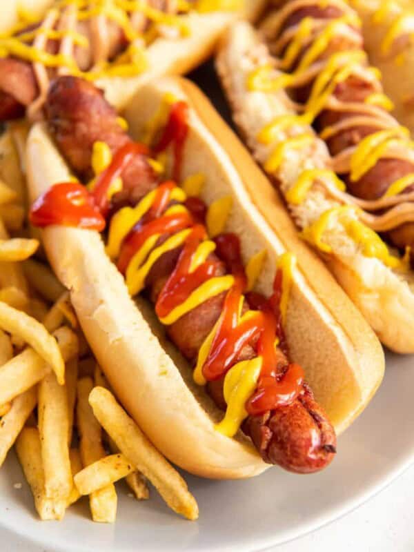 bacon wrapped hot dog with condiments