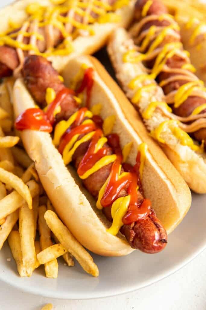 bacon wrapped hot dog with condiments