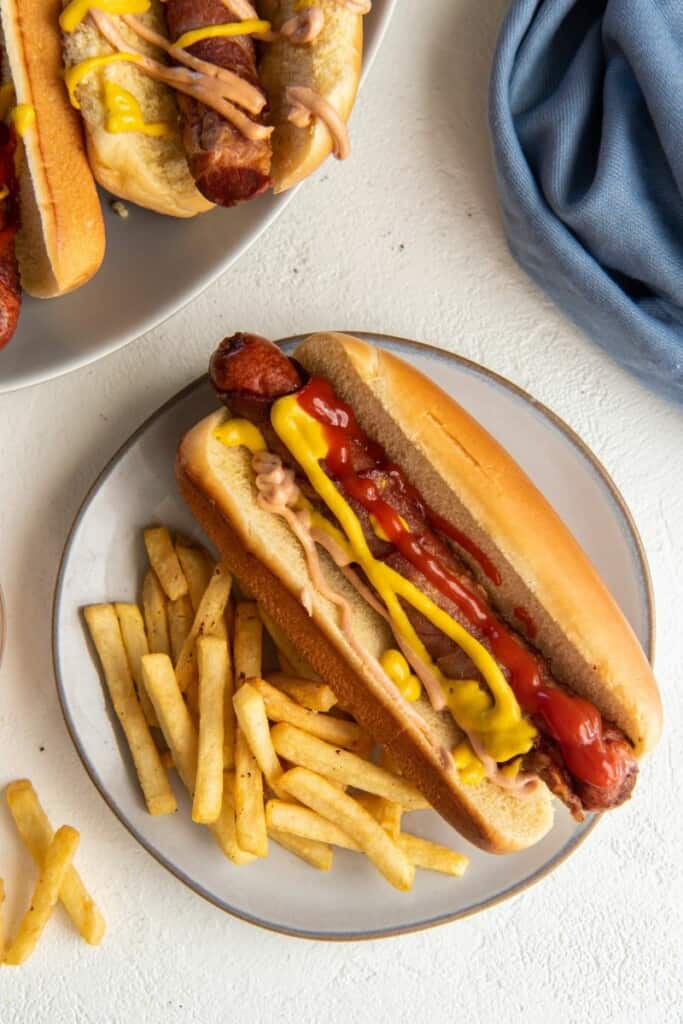 french fries with a bacon wrapped hot dog