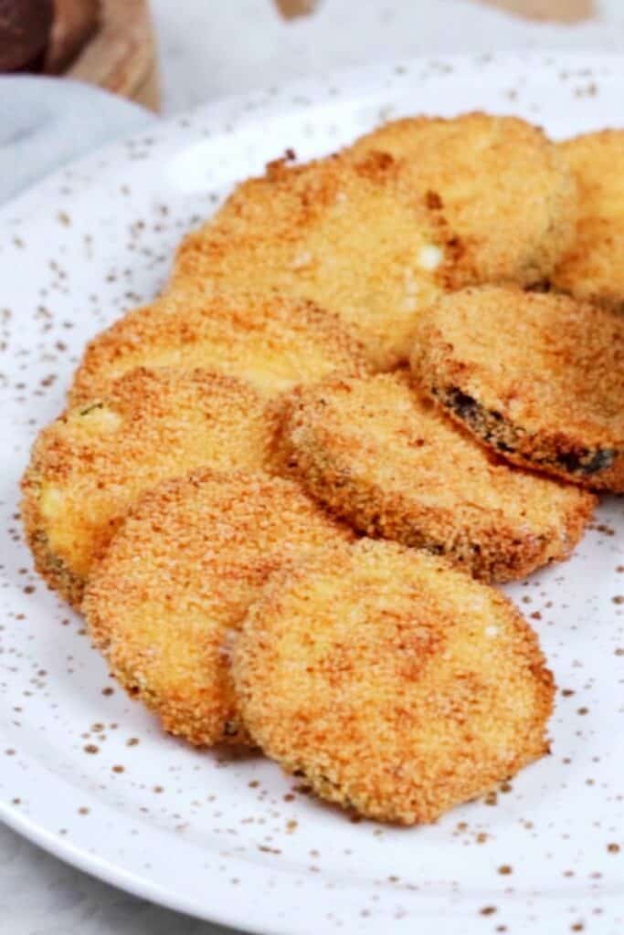 Breaded air fryer zucchini chips on a plate