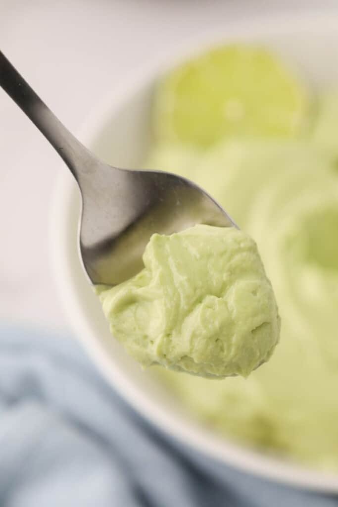 Closeup of spoonful of avocado crema