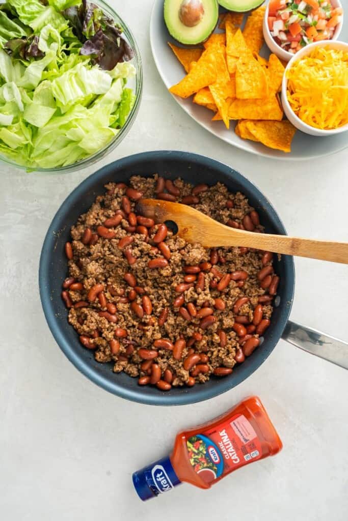 stirring meat in skillet