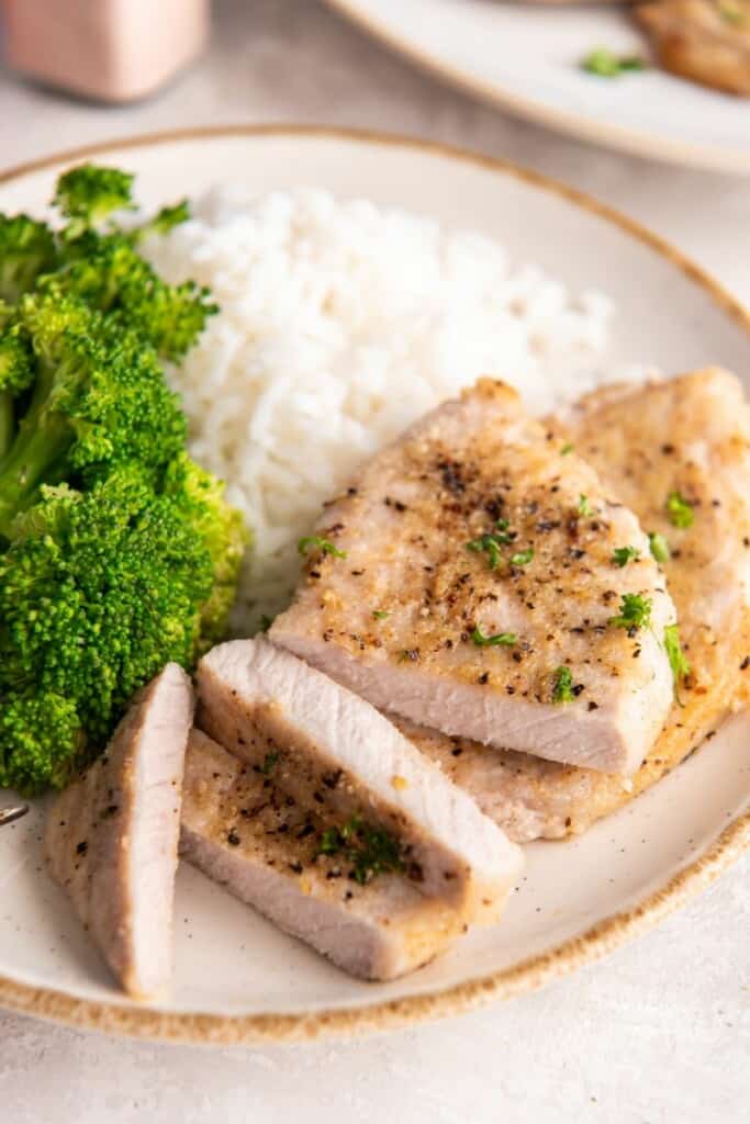 sliced pork chops with rice and broccoli