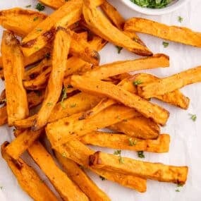Air fryer sweet potato fries from overhead with crispy pieces.