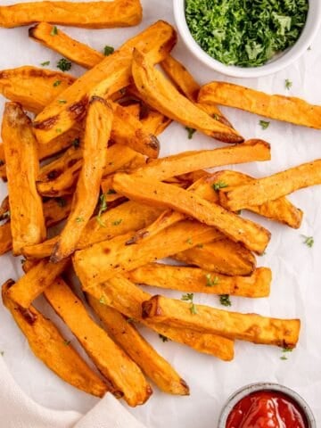 Air fryer sweet potato fries from overhead with crispy pieces.