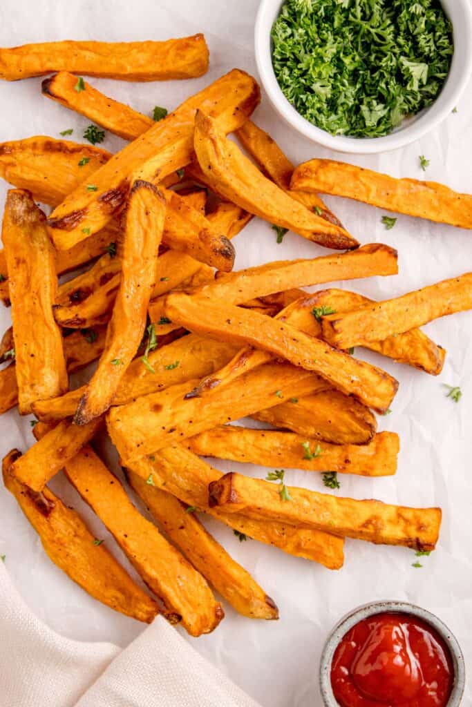 Air fryer sweet potato fries from overhead with crispy pieces.