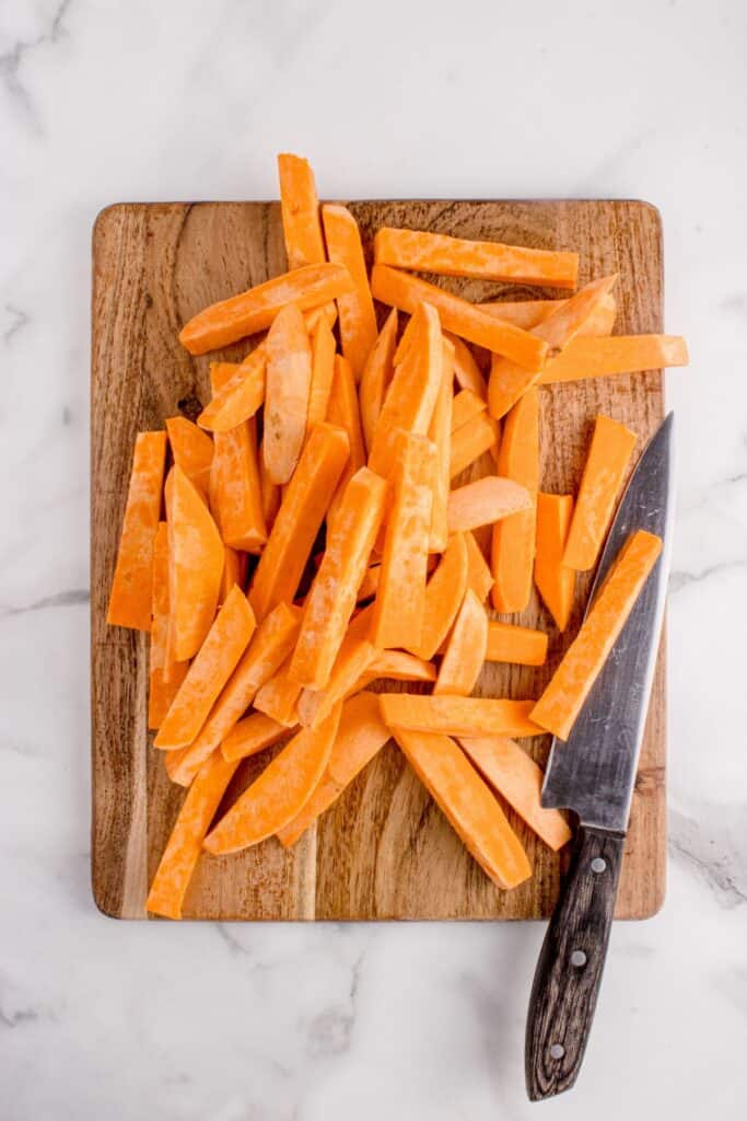 Sweet potatoes peeled and sliced into fries.