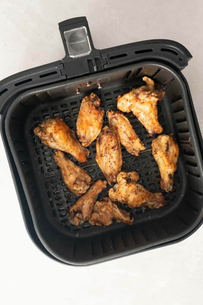 cooked air fryer wings in basket.