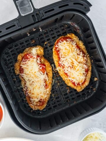 air fryer with melted cheese on chicken parmesan