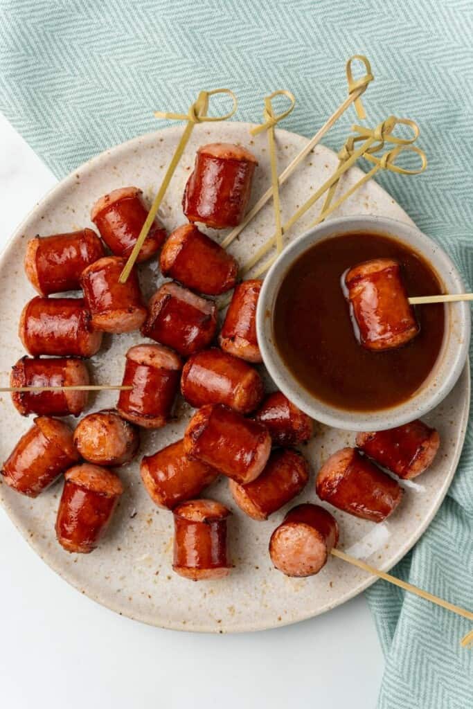 dipping smoked sausage into sauce