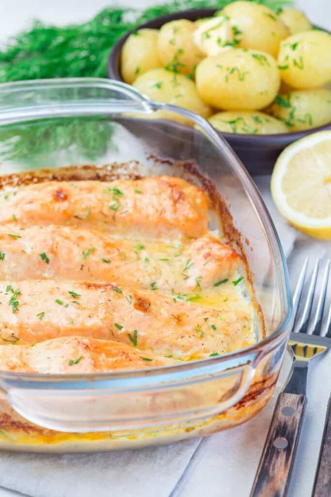 Salmon in a cream sauce in a glass baking dish