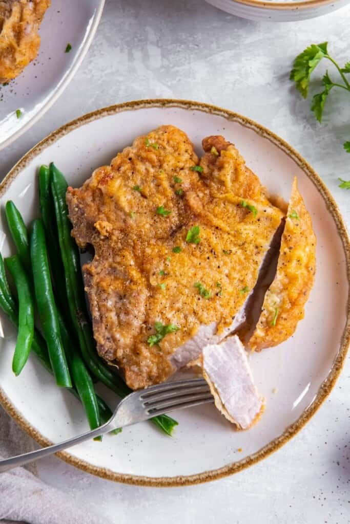 fork with pork chops and green beans