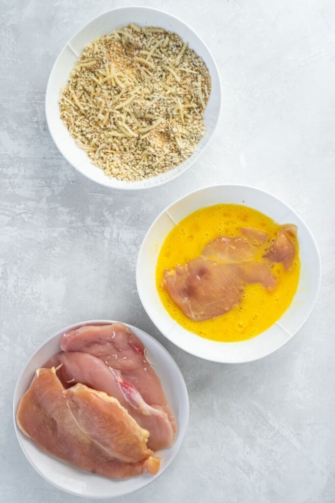 Sticking the chicken in the egg mixture.
