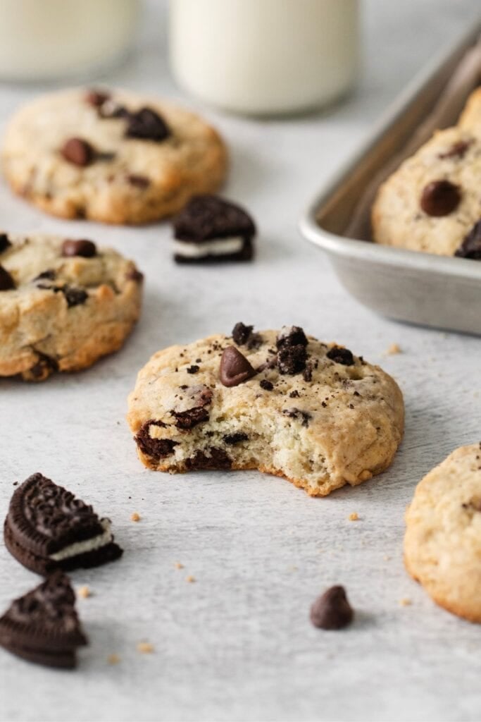 A bite taken out of the cookies and cream cheesecake cookies so you can see the inside texture of the cookie.